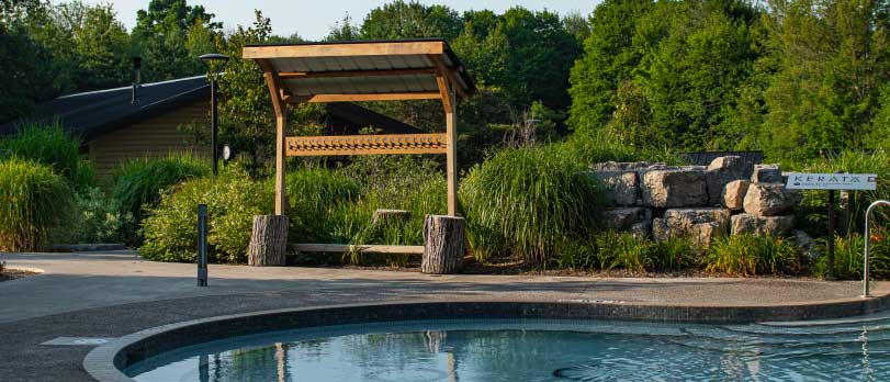 A view of a hot pool at Vetta Nordic Spa in summer